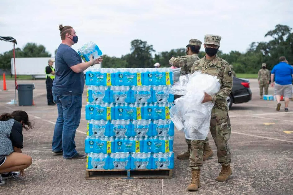 Soldiers and volunteers hand out water to Lake Jackson residents on Monday at Brazosport College. The free water handouts have been taking place since Saturday after residents were warned of a brain-eating amoeba found in Lake Jackson’s water supply. Photo Credit: JENNA KIESER/The Facts