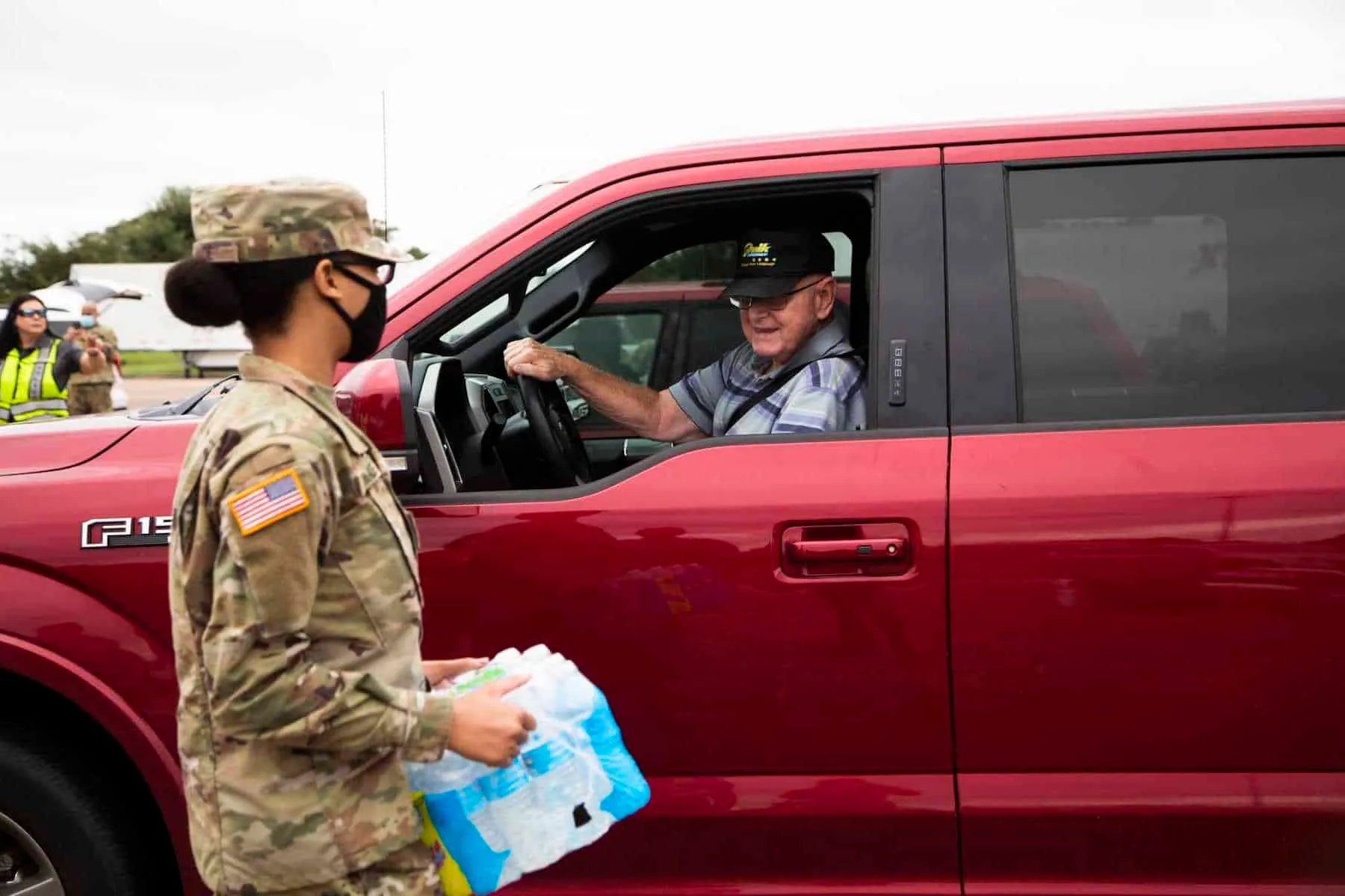 National Guard Pvt. Anaiya Wade, 19, carries bottled water to the back of a truck during a distribution in Lake Jackson.Photo: Marie D. De Jesús, Houston Chronicle / Staff photographer