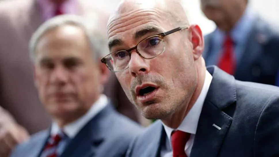 Texas House Speaker Dennis Bonnen, with Gov. Greg Abbott in the background.