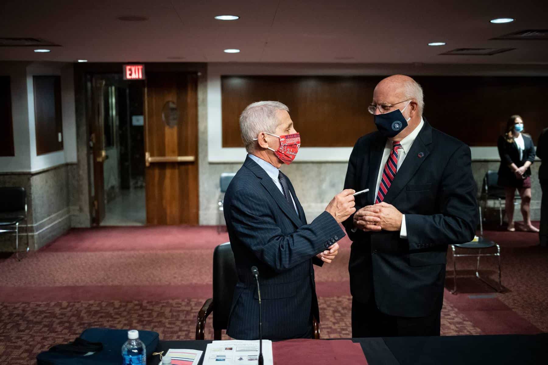 “Wearing a face covering is a critically important tool,” said Dr. Robert Redfield, right, director of the Centers for Disease Control and Prevention.Credit...Pool photo by Al Drago